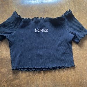 Ruffled Crop Top with the words "Honey" written across it. Letters slightly pink